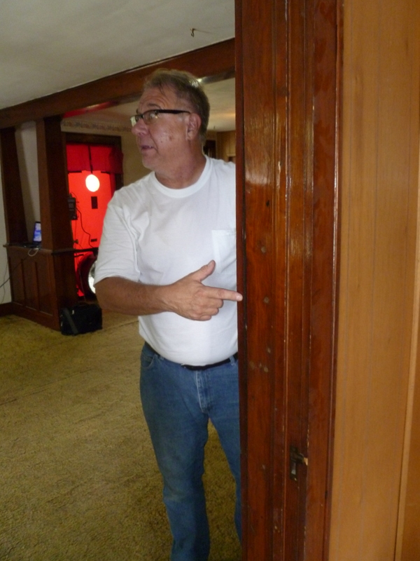 Ron Zmyslo, pointing out air flowing up from the basement through a door jamb on the first level.